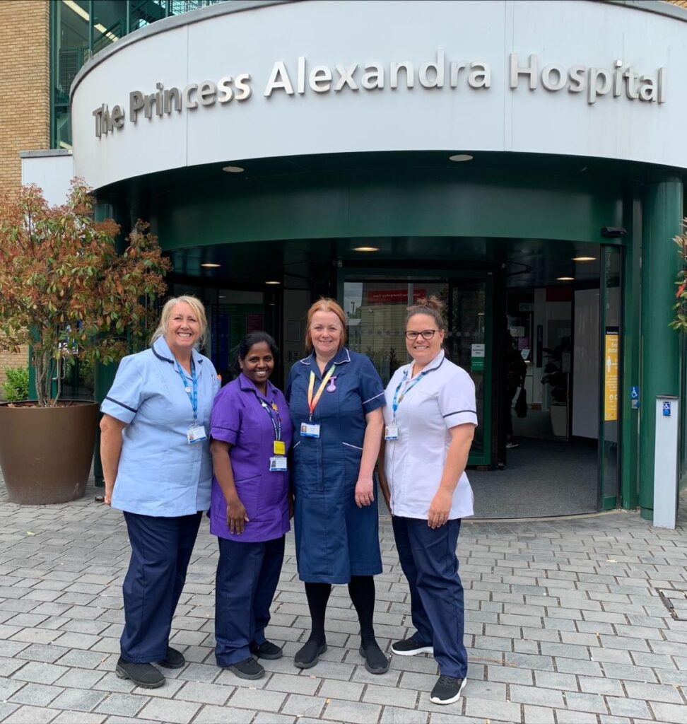 Nurses stood outside the entrance of The Princess Alexandra Hospital