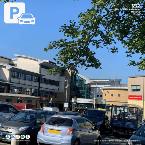 Hospital Car park with several parked vehicles in front of the Princess Alexandra Hospital building.