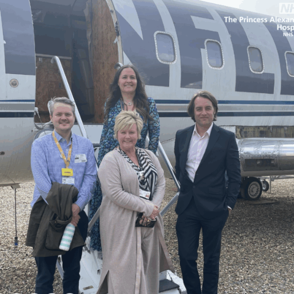 Thom Lafferty, chief executive at The Princess Alexandra Hospital NHS Trust (PAHT), Jamie Coates, head of people resourcing and retention at PAHT, Karen Spencer, Principal and CEO of Harlow College and Victoria Clayden Smith, Head of Centre at Stansted Airport College standing beside an aircraft at Stansted Airport College.
