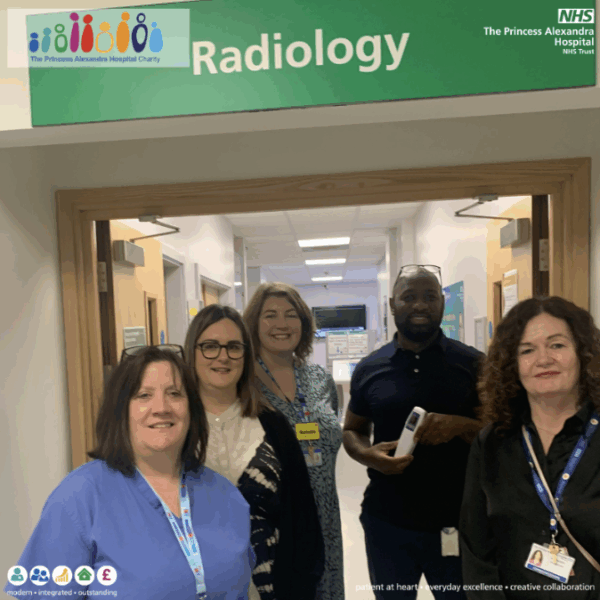 Hospital staff stand below Radiology department sign
