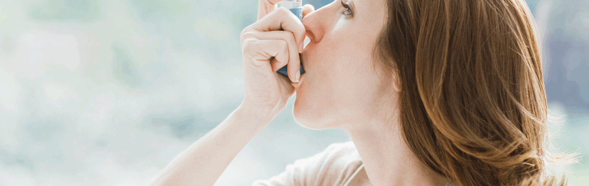 Woman using an inhaler