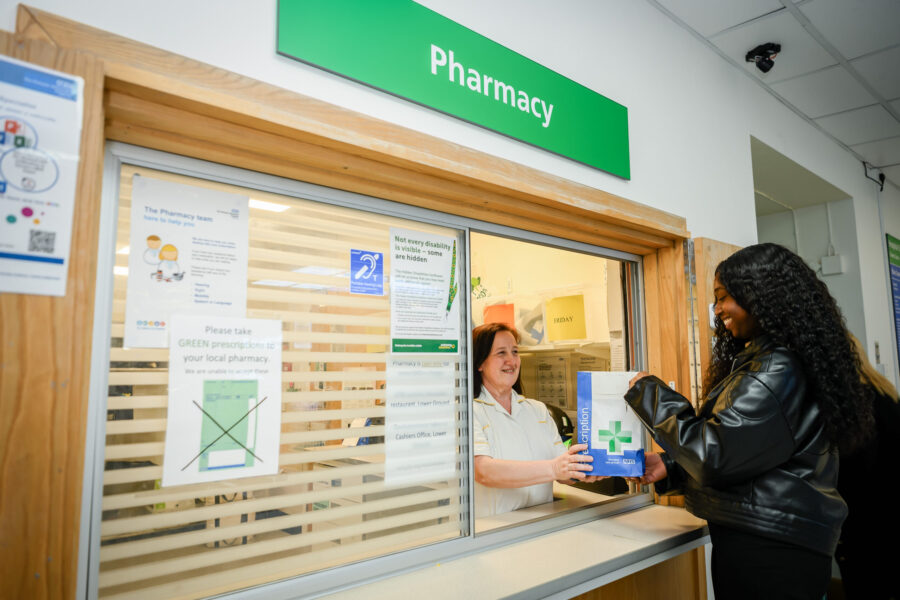 two woman at Pharmacy dispensary window