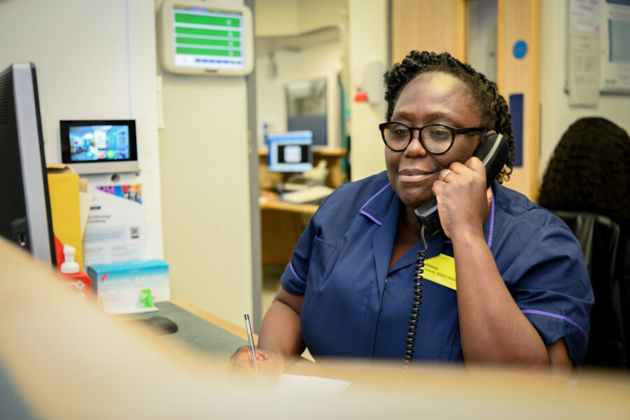 Nurse sat at a desk on the phone